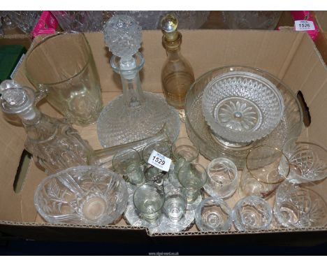 A quantity of glass including decanters, sherry glasses on a carousel, small cut glass brandy glasses etc.