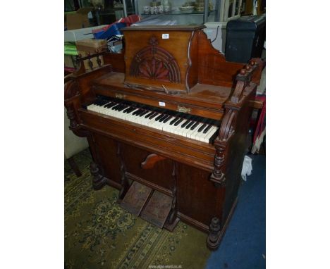 A mixed woods 4 1/2 octave Harmonium of arts and craft design with fretwork decoration, turned details, etc. 42'' wide x 17 1