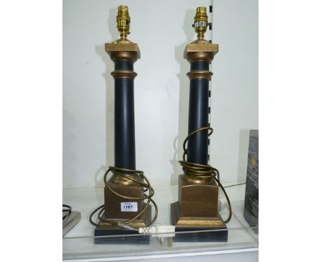 A pair of table Lamp bases with smooth black columns on gold coloured square bases and corresponding smaller tops, 21" tall.