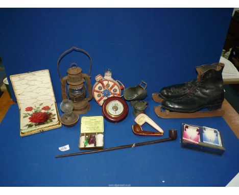 A quantity of miscellanea including a pair of skates by Mitchell & Co.,Tilly lamp, small oil lamp, beaded wine bottles. pipes