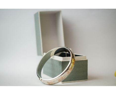 A fully hallmarked sterling silver cuff bangle with rose gold decoration in original retailers box. 