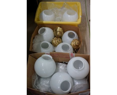 A large collection of white globe ceiling lights with brass fittings. 