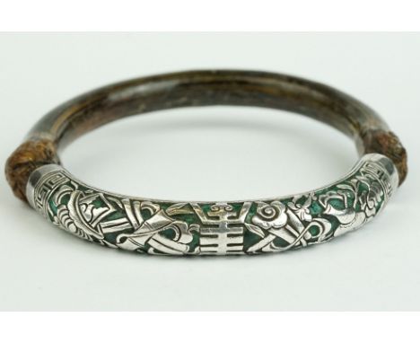 An oriental wood and white metal bangle. 