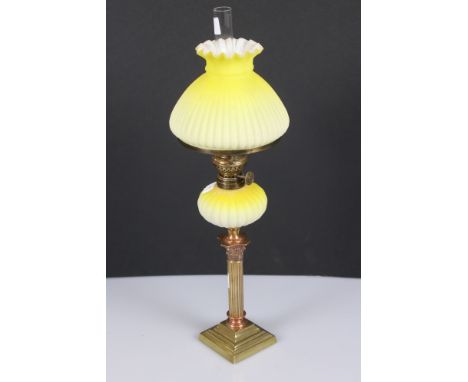 Early 20th century peg lamp with graduated yellow ribbed font and matching shade, a brass and copper Corinthian column candle