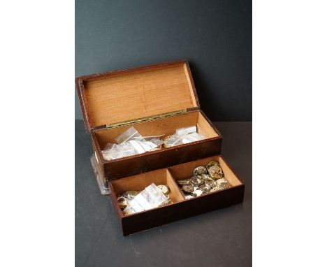 A collection of vintage watch parts and watch movements within a wooden box. 