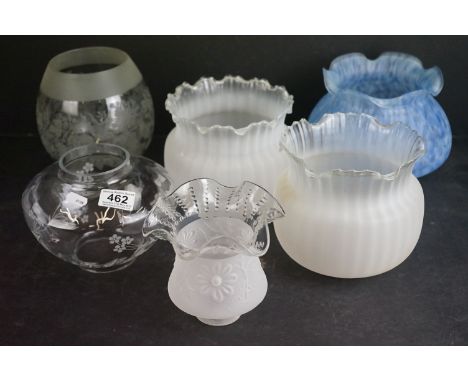A collection of six glass oil lamp shades of various patterns and sizes. 