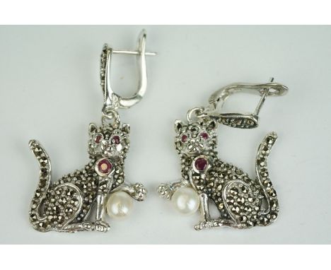 Pair of silver marcasite cat drop earrings, set with rubies and pearl drop 
