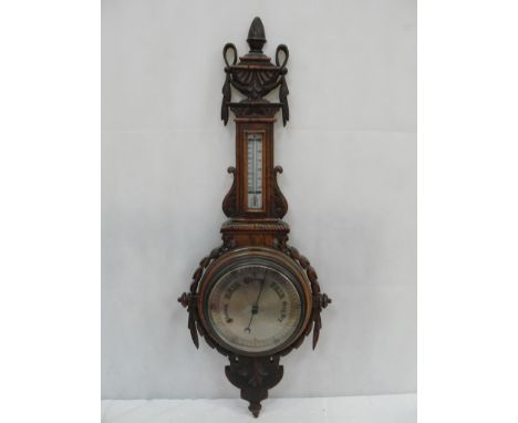 A victorian silver dialed oak barometer