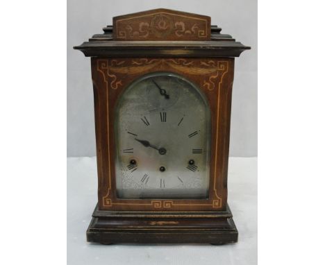 An edwardian mahogany cased silver dialled bracket clock