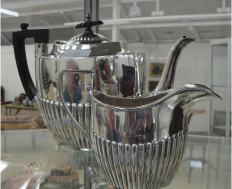 A Hallmarked silver teapot Sheffield 1915 together with a HM silver cream jug Birmingham 1914