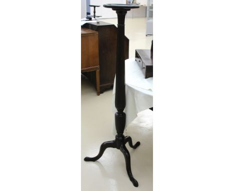 A mahogany torcherre on tripod feet