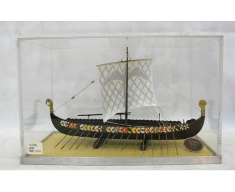 A boxed and cased model of a Viking ship