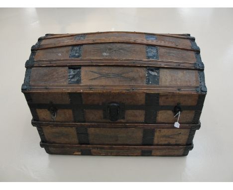 A leathered covered domed  travelling trunk