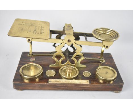 A Late 19th/Early 20th Century Brass Postage Scales with Weights on Rectangular Wooden Plinth, 26.5cms Wide 
