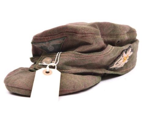 A Third Reich field grey soft ski cap, with BeVo woven one piece eagle and cockade on green patch, and embroidered edelweiss 