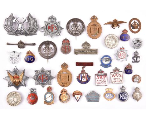 31 various WWI and WWII period lapel and pin back badges, including WWI “Services Rendered” (2), “On War Service 1915” (2), W