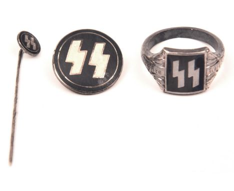 A Third Reich SS silver ring, with runes set in black enamel. An SS tie pin and circular enamelled lapel badge. GC (3) £70-80