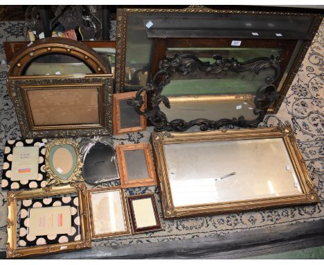 A quantity of mirrors and picture frames, including an Art Nouveau style brass easel photo frame; a circular Regency style mi