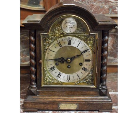 An oak cased mantel clock, Jungens movement, brass dial, part silvered, presentation plaque 1929, key