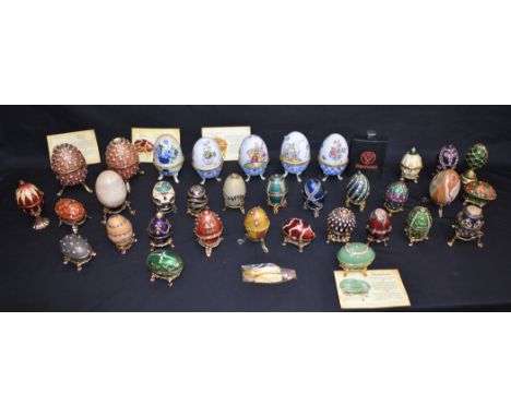 A collection of Faberge style enamel eggs; other enamel eggs
