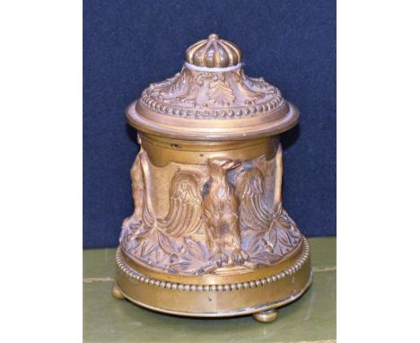 A 19th century ormolu inkwell, cast in relief with eagles, hinged cover, bun feet, 13cm high, c.1860