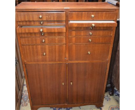 A 20th century mahogany medical/collectors cabinet, rectangular top above an arrangement of shallow drawers and a pair of cup