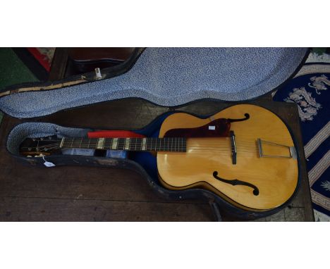 A Zenith arch top six-string acoustic jazz guitar, faux tortoiseshell scratch plate, serial no. M427G, paper label with facsi