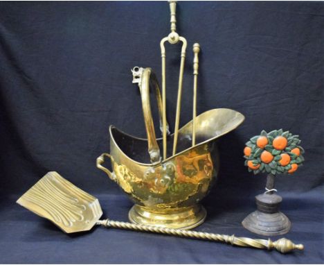 Brass and Metalware - a Victorian brass helmet coal scuttle; a set of four brass fire irons; a cast iron orange tree doorstop