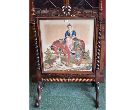 A Victorian rosewood firescreen, fretwork leafy scroll cresting, the rectangular Berlin woolwork banner depicting a lady on h