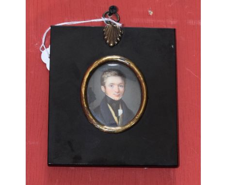 English School (19th century), a portrait miniature, of a young gentleman wearing a blue coat, yellow waistcoat and black sto