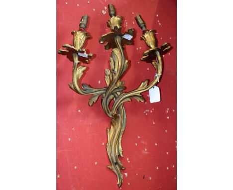 A pair of Rococo Revival ormolu three-light wall sconces, cast throughout with acanthus, 45cm long