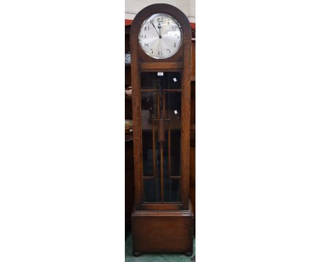 A 1930's Art Deco longcase clock, glazed case, silvered dial, Arabic numerals, raised on bun feet, weights and pendulum