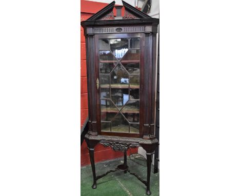 A Chippendale revival mahogany corner cabinet on stand, possibly Irish, architectural pediment above a deep frieze and an ast