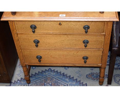 A 20th century light oak dressing table, of narrow proportions, moulded top with adjustable mirror above three long drawers, 