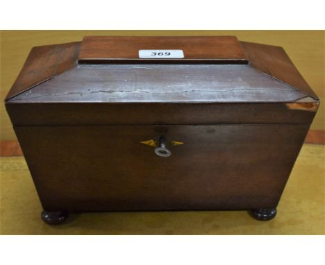 A 19th century mahogany sarcophagus shaped tea caddy, hinged cover enclosing two lidded compartments and a circular recess, b