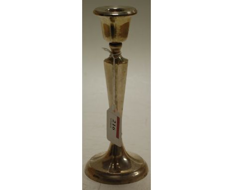 A silver candlestick on loaded base