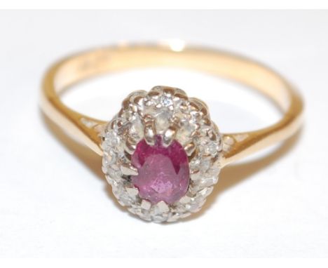 A ladies 18ct gold ruby and diamond point set cluster ring