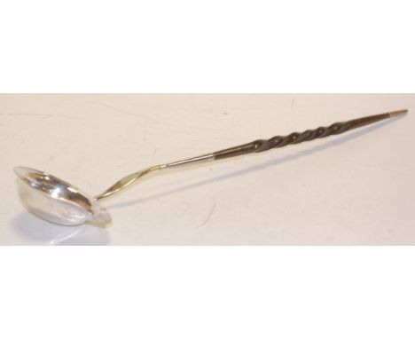 A 19th century white metal and whale bone handled toddy ladle