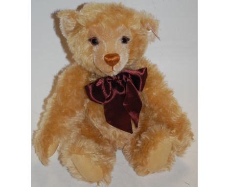 Steiff No.670374 red and white tagged light blond teddybear, dated 1999, with maroon bow, working growler, in original box, n