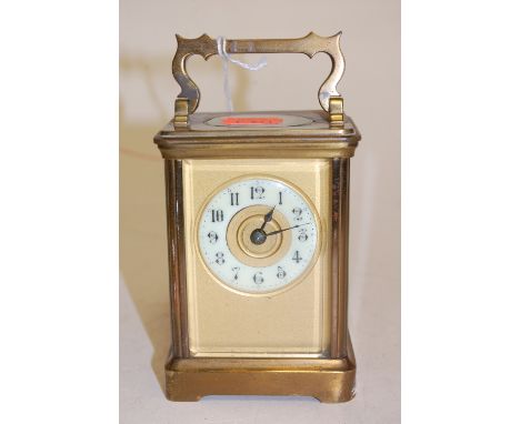 A circa 1900 French lacquer brass carriage clock having white enamel chapter ring