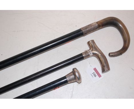 A late Victorian silver topped and ebonised walking cane; and two others to include one with silver and horn handle (3) Condi