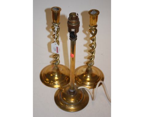 A pair of spiral turned brass candle holders and a brass lamp base (2) 