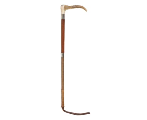 AN EDWARDIAN CHILDS HUNTING CROP with antler handle, silver hallmarked collar, leather grip and plaited shaft, by Swaine &amp