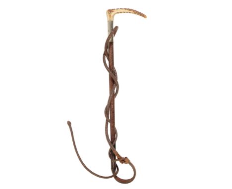 AN EDWARDIAN CHILDS HUNTING CROP with antler handle, nickel silver collar, leather plaited shaft and thong, 46cm longProvenan