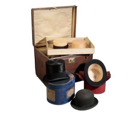 A VICTORIAN CANVAS AND LEATHER HAT TRUNK with a quantity of various hats, comprising straw boaters, one black bowler hat and 