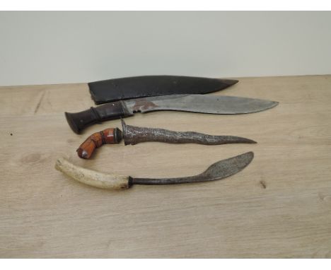 A Gurkha Kukri with wood handle and leather scabbard, blade length 32cm, overall length 42cm, Indonesian Kris with decorated 