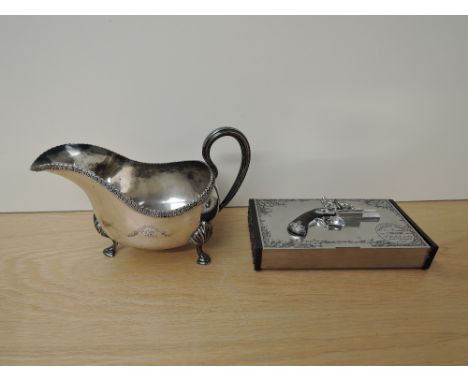 A Silver plated Sauce Boat marked Elkington, engraved 2nd Warwikshire along with a chrome Cigar Box with decorative Flintlock