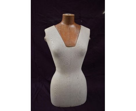 A wood and fibreglass cloth covered mannequin.
