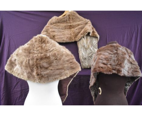 Three vintage light brown fur wraps or stoles, one with pockets.