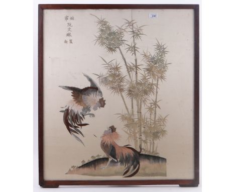 An embroidered silk panel,
with design of cockerels and bamboo, in glazed frame, signed, height 31" overall.